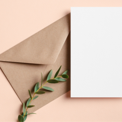 blank white card and envelope with a eucalyptus leaf