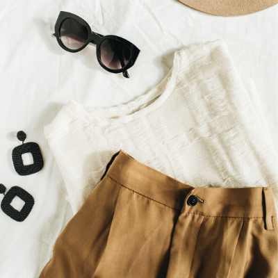 fashion moodboard of white top, khaki bottom, sunglasses, and black earrings