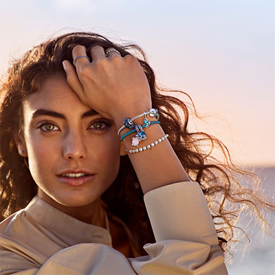 young woman wearing pandora bracelets and charms